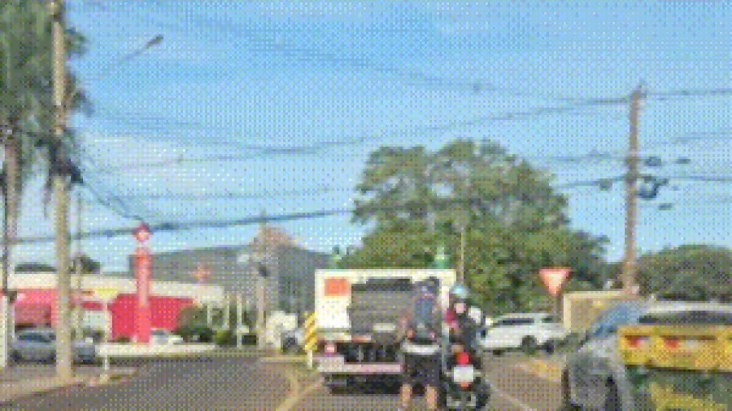 Brazil motorcyclist tows inline skater in suburban street
