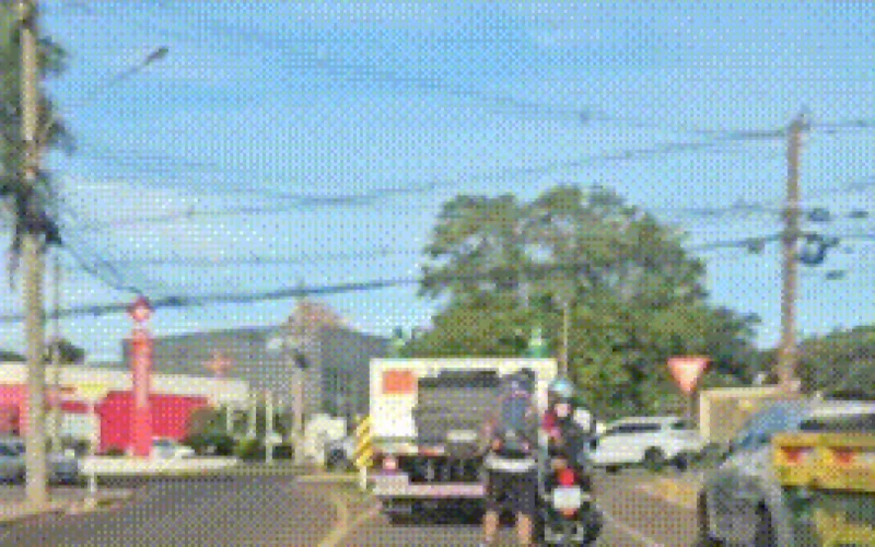 Brazil motorcyclist tows inline skater in suburban street